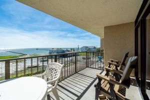 a balcony with a table and chairs and the ocean at Laguna Reef #315 - Bayview Retreat in Rockport +34 photos
