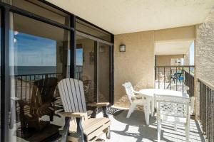 a patio with chairs and a table on a balcony at Laguna Reef #315 - Bayview Retreat in Rockport