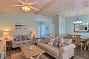 a living room with two couches and a dining room at Just Beachy in Port Aransas