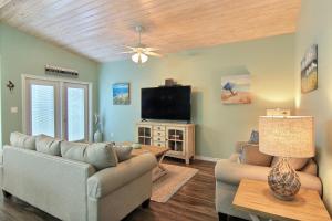 a living room with a couch and a tv at Just Beachy in Port Aransas
