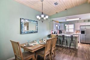 a kitchen and dining room with a wooden table and chairs at Just Beachy in Port Aransas +33 photos