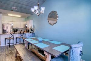 a dining room and kitchen with a wooden table and chairs at Flip Flops & Pop Tops in Port Aransas +33 photos