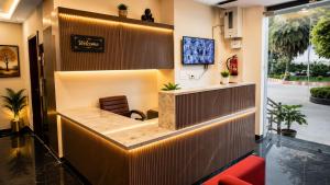 an office lobby with a waiting room with a chair at Hotel Prime Grand Residency by Rd Hotels #Most Premium Hotel in vrindavan #Lift #Parking #Fully Ac in Chhatikara