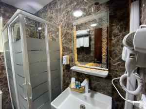 a bathroom with a sink and a mirror at Golden Pyramids Inn in Cairo +105 photos