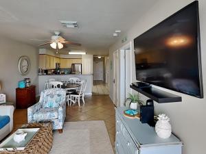 a living room with a large flat screen tv at Port A Condo in Port Aransas