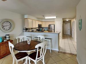 a kitchen and dining room with a table and chairs at Port A Condo in Port Aransas