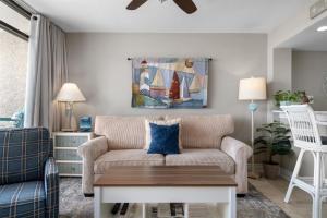a living room with a couch and a table at Laguna Reef #213 - Four Point Lighthouse in Rockport