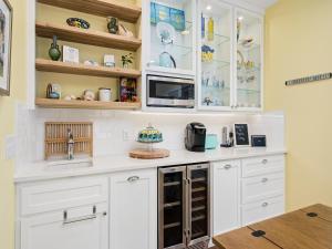 a kitchen with white cabinets and a counter top at Magnolia Cottage in Rockport
