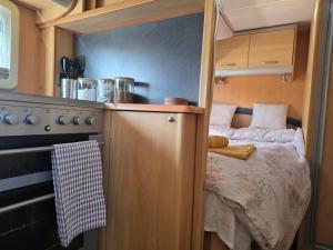 a small room with a bed in a kitchen at Sterling Leisure in Ferryhill