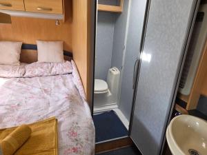 a small bedroom with a bed and a sink at Sterling Leisure in Ferryhill +20 photos