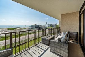 a balcony with two couches and a view of the ocean at Laguna Reef #215 - Tequila Sunrise in Rockport