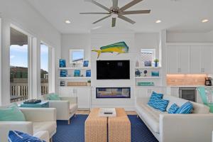 a living room with a couch and a tv at The White House in Padre Island