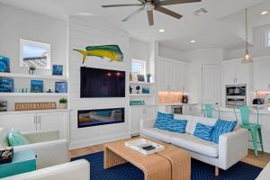 a living room with a couch and a tv at The White House in Padre Island