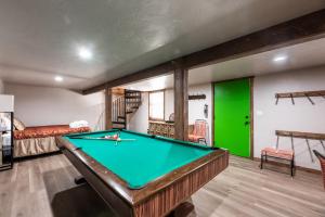 a pool table in a room with a green door at The Great Escape in Ruidoso