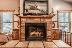 a fireplace with a television on top of it at The Great Escape in Ruidoso +31 photos