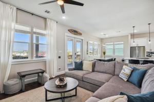 a living room with a couch and a table at Sandy Cheeks Surfside in Surfside Beach