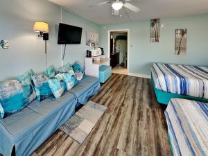 a living room with a couch and a bed at Laguna Reef #121 - Gone Coastal in Rockport