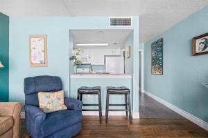 a living room with a bar and a blue wall at Laguna Reef #211 - Rod and Reel in Rockport +44 photos