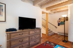 a living room with a television on a dresser at Las Brisas 24 in Santa Fe