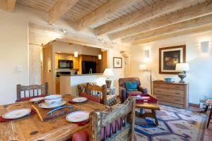 a dining room with a wooden table and chairs at Las Brisas 24 in Santa Fe
