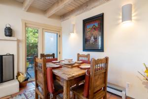 a dining room with a wooden table and chairs at Las Brisas 24 in Santa Fe