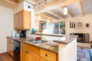 a kitchen with a sink and a counter top at Las Brisas 24 in Santa Fe +18 photos