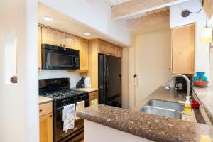 a kitchen with a stove and a sink at Las Brisas 24 in Santa Fe