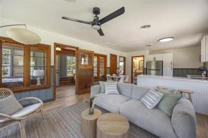 a living room with a couch and a kitchen at Willow Heaven - Lakefront Cabin Escape in Madill