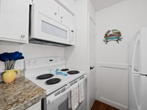 a kitchen with a stove and a microwave at Beautiful Bay View Condo in Rockport +18 photos