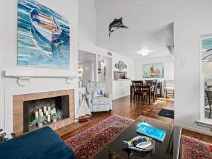 a living room with a fireplace and a dining room at Beautiful Bay View Condo in Rockport