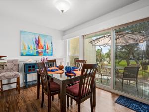 a dining room with a table and chairs and a patio at Beautiful Bay View Condo in Rockport