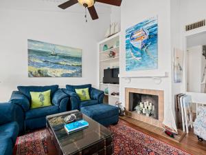 a living room with a blue couch and a fireplace at Beautiful Bay View Condo in Rockport
