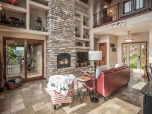 a living room with a couch and a fireplace at Avalon in Ruidoso