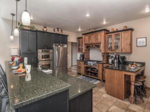 a large kitchen with wooden cabinets and granite counter tops at Avalon in Ruidoso