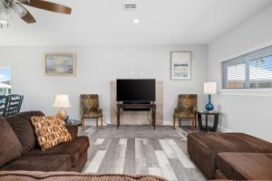 a living room with a couch and a flat screen tv at Edgewater Escape in Rockport