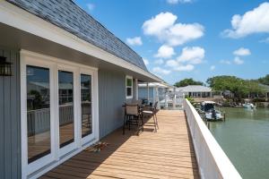a house with a deck with a view of the water at Edgewater Escape in Rockport