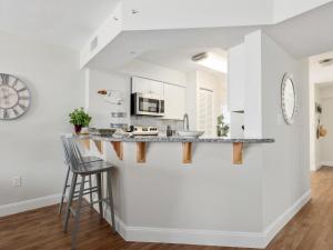 a kitchen with white walls and a counter at Sea Winds 501 - Corner Breeze in Ormond Beach