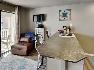 a living room with a table and a chair at Villa Del Sol #2138 in Corpus Christi