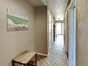 a hallway with a bench and a painting on the wall at Villa Del Sol #2138 in Corpus Christi