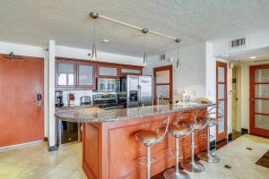 a kitchen with a island with bar stools at San Luis 935-Luis Lookout in Galveston