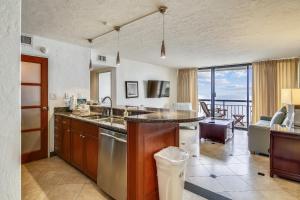 a kitchen with a sink and a table with a view at San Luis 935-Luis Lookout in Galveston +17 photos