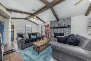a living room with two couches and a fireplace at Castle House in Ruidoso