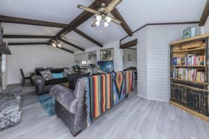 a living room with a couch and a book shelf at Castle House in Ruidoso