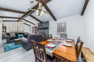 a dining room and living room with a table and chairs at Castle House in Ruidoso +19 photos