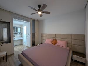 a bedroom with a bed and a ceiling fan at Villa SUN SQUARE DJERBA in Awlād ‘Umar +28 photos