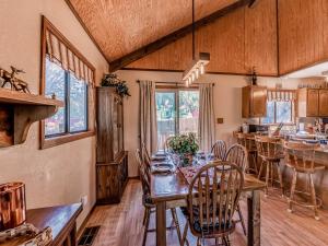 a kitchen and dining room with a table and chairs at Mockingbird Cabin in Ruidoso +31 photos