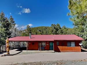 a red building with a red roof at Touch of Santa Fe in Ruidoso