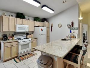 a kitchen with white appliances and a counter top at Touch of Santa Fe in Ruidoso +13 photos