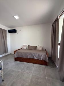 a bedroom with a bed in the corner of a room at Don Sánchez in Cafayate