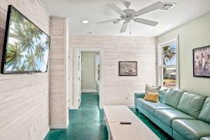 a living room with a couch and a ceiling fan at Above & Beyond in Port Aransas